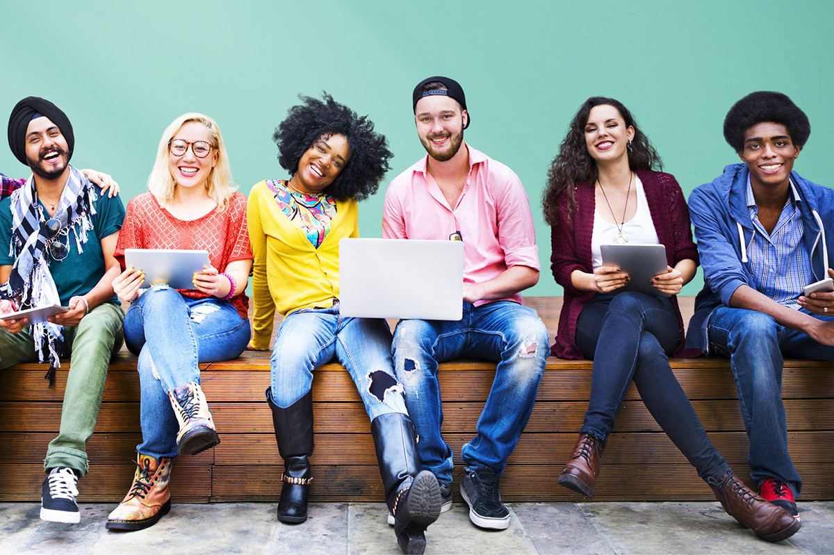 a diverse group of students smiling and looking at the camera